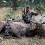 An Elk Ridge Outfitters guest poses with the elk he caught on his trip