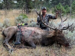 An Elk Ridge Outfitters guest poses with the elk he caught on his trip