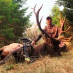 An archery hunter at Elk Ridge Outfitters posing with his kill